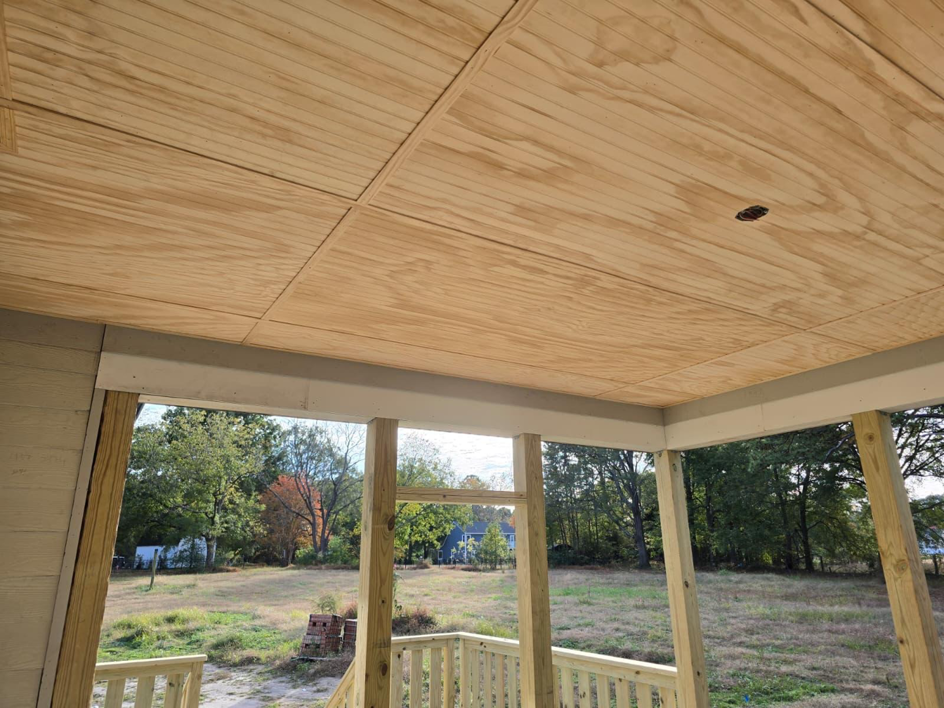 View of a newly installed plywood porch ceiling and wooden support structure by MAF Construction LLC in Raleigh, NC