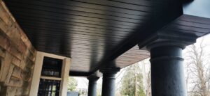 Close-up of a newly installed dark porch ceiling and soffit, a handyman job by Ideal Siding Memphis, TN