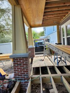 Porch and deck construction in progress with visible framing and brick columns by Alejandro Melo Contractor corp in Tampa, FL.