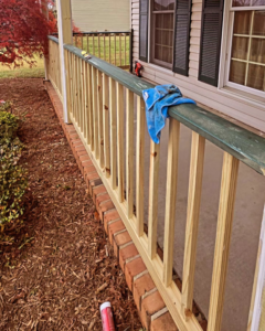 A porch railing repair and painting project in progress, handled by DEMIA 17 & Company LLC in Waldorf, MD.