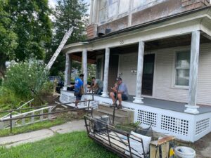 Construction workers performing repair and renovation work on a residential porch by Usa Construction of Danbury LLC in Danbury, CT.