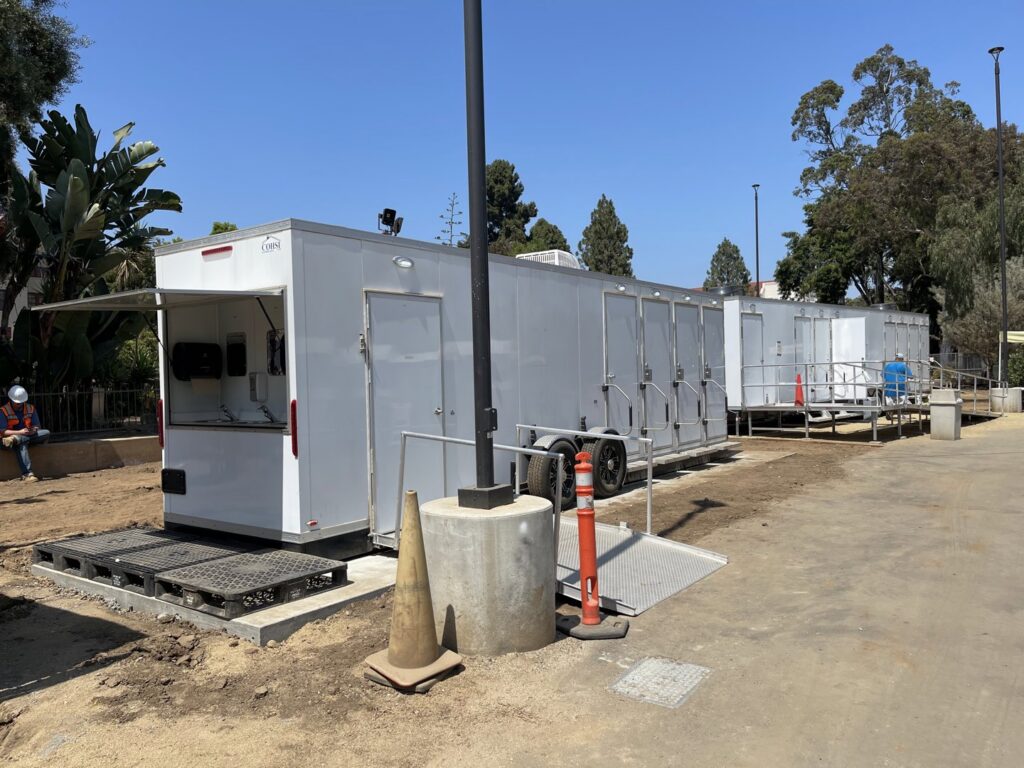 Multiple portable restroom and facility trailers set up on a site, managed by Comforts of Home Services Inc in Aurora, IL