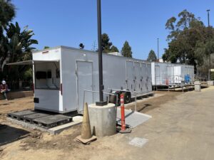 Multiple portable restroom and facility trailers set up on a site, managed by Comforts of Home Services Inc in Aurora, IL