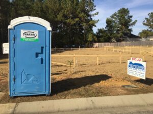 A Martin Environmental portable toilet on a cleared residential lot in Dothan, AL.