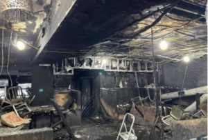 A severely fire-damaged commercial interior filled with debris, ready for post-fire cleanup and junk removal by We Love Trash OH in North Canton, OH.