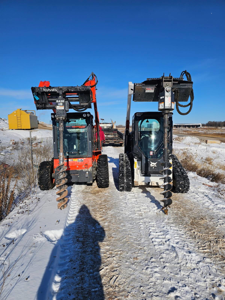 Compact utility loaders with auger attachments for post hole digging during fence installation by Fox Valley Fencing LLC in Appleton, WI