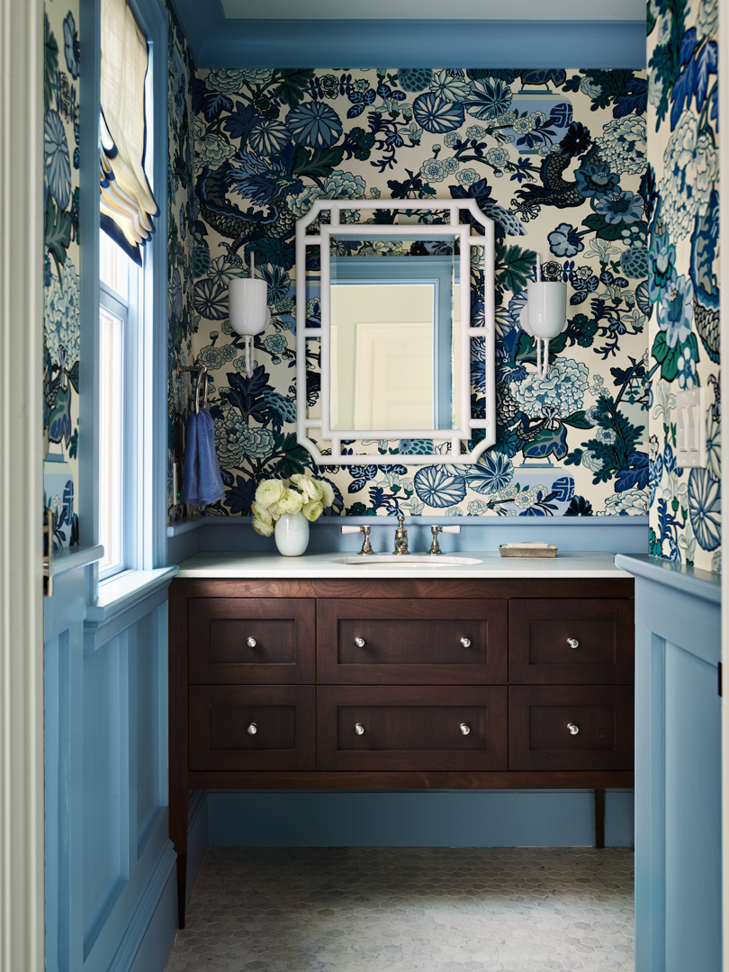 A stylish powder room remodel with blue wainscoting and patterned wallpaper by FH Perry Builder in Hopkinton, MA.