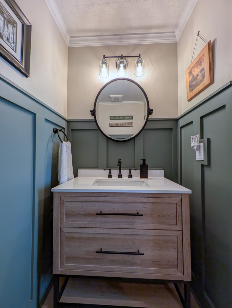 A newly installed vanity, sink, and mirror in a powder room by Renew Additions & Remodeling, LLC in Columbus, OH.