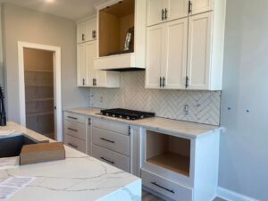 A newly renovated powder room with a modern vanity, mirror, and dark floor tiles by CSR Tile Construction LLC in Minneapolis, MN.