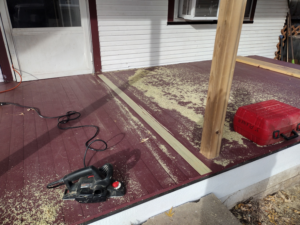 A power planer on a porch deck with wood shavings, indicating deck work by Do-N-All Handyman Service in Wichita, KS.