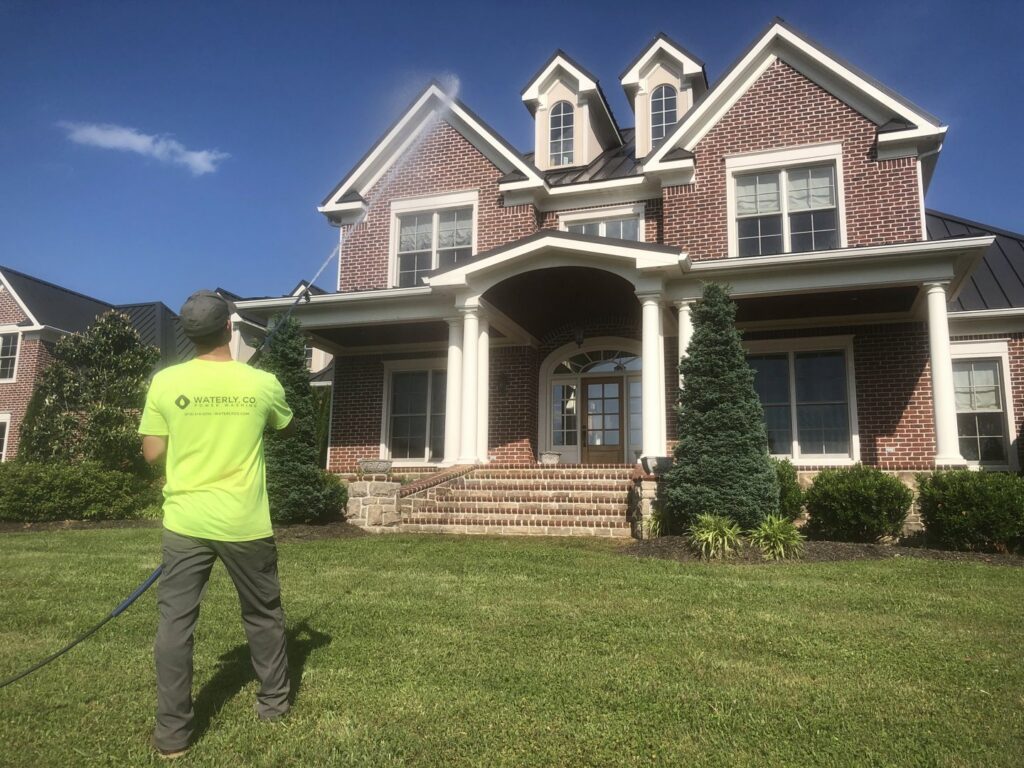 A Waterly, Co. Power Washing technician power washing a pool patio area in Nashville, TN.