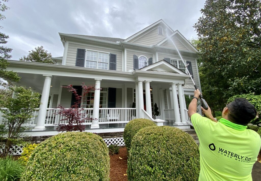 A Waterly, Co. Power Washing technician power washing residential siding in Nashville, TN.