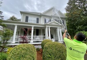 A Waterly, Co. Power Washing technician power washing residential siding in Nashville, TN.