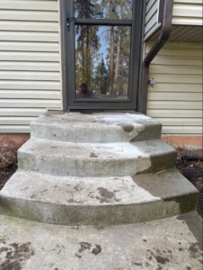 Concrete steps being pressure washed, showing clean and dirty sections by SlabJack Geotechnical in East Wenatchee, WA.