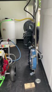 Professional pressure washing equipment and water tanks inside a service trailer for In Goode Hands LLC in Beckley, WV.