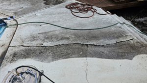 A concrete pool deck being professionally pressure washed by Done Right Handy in Wilmington, DE.