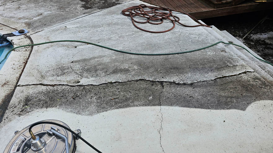 A concrete pool deck being professionally pressure washed by Done Right Handy in Wilmington, DE.