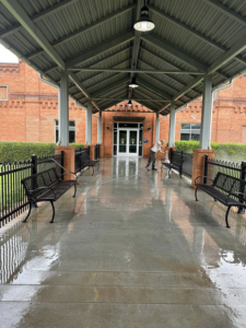 A professional pressure washing service cleaning a station walkway, provided by S & S Pressure Washing and Painting Co. in Burlington, NC.