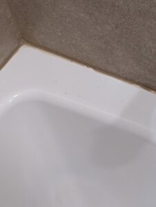 Close-up of professional caulking around a bathtub or shower base, a detail-oriented service by H4 Construction and Remodeling in Blue Springs, MO.