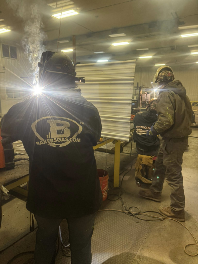 Professional welders performing metal fabrication work at Siva Steel LLC in Saginaw, MI.