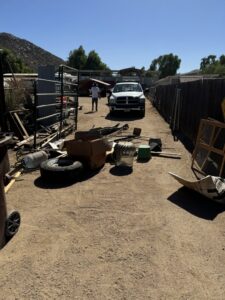 A property cleanout scene with scattered debris, tires, and boxes, handled by New Haul Junk Removal in Los Angeles, CA.