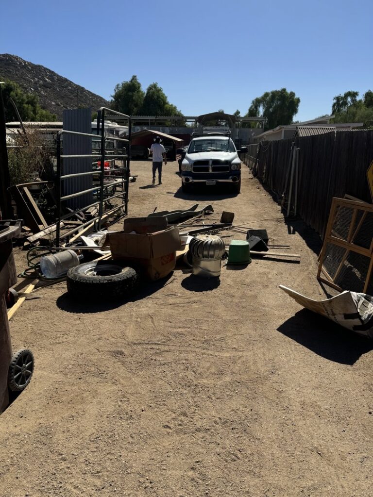 A property cleanout scene with scattered debris, tires, and boxes, handled by New Haul Junk Removal in Los Angeles, CA.