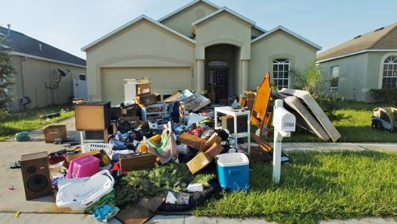 A large pile of household junk on a driveway, ready for removal by Omaha junk Removal and Hauling Service in Omaha, NE.