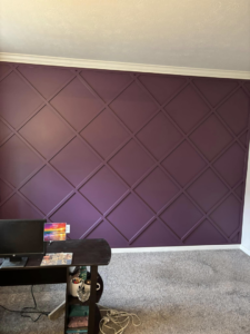 A beautifully installed purple accent wall with diamond-patterned trim by Shawn's Handyman Services in Fishers, IN.