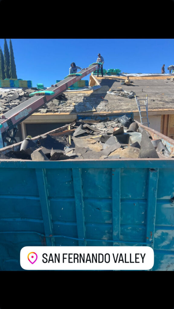 A Quality Bin Inc. dumpster filled with roofing debris at a job site in San Fernando Valley, Los Angeles, CA.