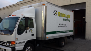 A Quick Light Recycling truck parked outside a facility in South San Francisco, CA, ready for junk removal.
