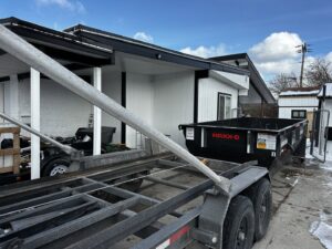 A RAAAM Dumpster Rentals roll-off dumpster being delivered to a property in Salt Lake City, UT.