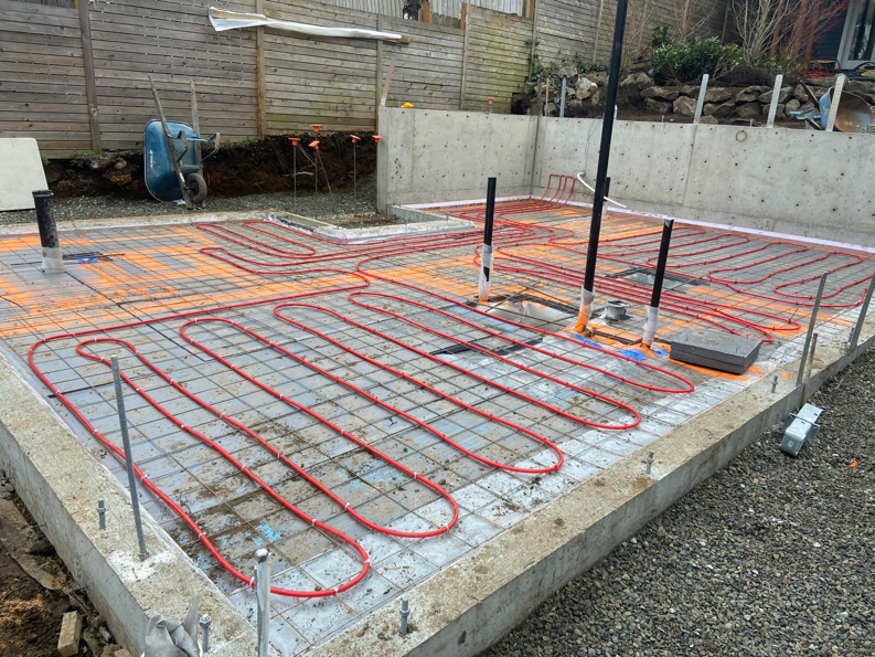 Radiant heating pipes installed within a concrete foundation, a service provided by Mode Contracting in Seattle, WA.