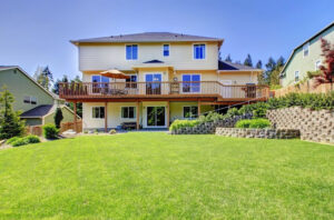 A large raised backyard deck overlooking a green lawn by St. Charles Deck in St. Charles, MO