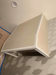 A custom range hood frame with corner beads installed, ready for plastering by Plasters of Italy in Plano, TX