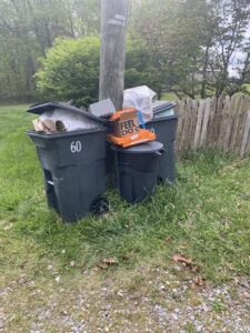 The rear of a garbage truck with a "SLOW DOWN TO GET AROUND" warning sign from Whitecap Waste in Beckley, WV.