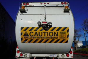 Rear view of a recycling truck with a caution sign, part of Green Solutions Recycling's fleet in Reno, NV.