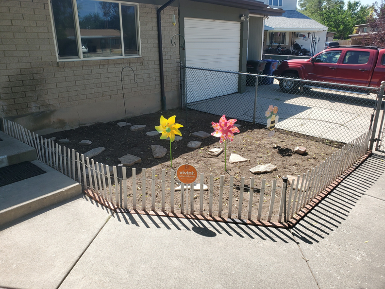A rectangular garden bed prepared with bare soil by Papa Bear's Home Care in West Valley City, UT.