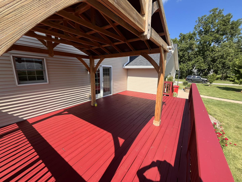 A large red painted deck with a covered area by McDonald Residential Contracting in Ames, IA.