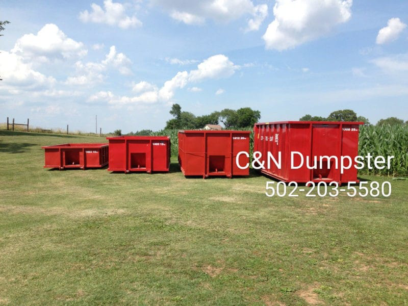 Several red dumpsters of various sizes available from C&N Dumpster in Louisville, KY