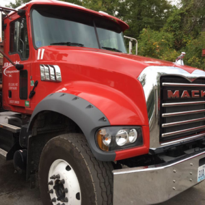 A close-up view of a red Mack disposal truck from Beck Disposal Inc. in St. Louis, MO