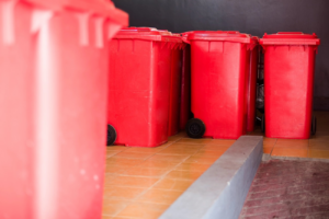Red medical waste disposal bins ready for collection by Med Waste Gone, a junk removal provider in St. Louis, MO.