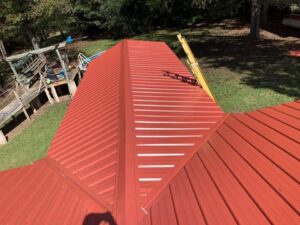An aerial view of a vibrant red metal roof installation by Hill Renovations LLC, providing durable roofing in Athens, GA