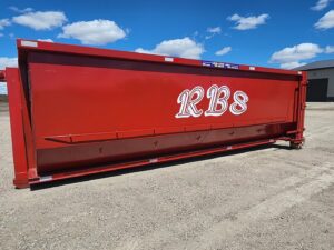 A large red roll-off dumpster with the RBS Sanitation Inc. logo, ready for junk removal services in Tea, SD.
