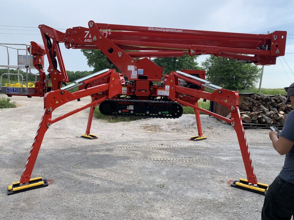 A red spider lift, a specialized piece of tree care equipment, used by Top Notch Tree Care in Holt, MI.