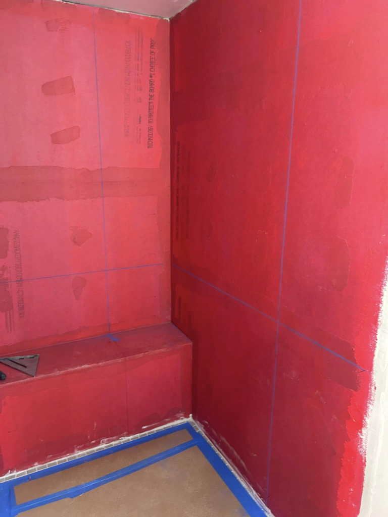 Shower walls and floor prepared with red waterproofing membrane by G-P Construction in Springfield, OR.