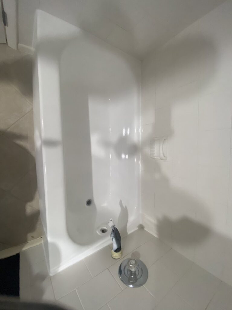 A newly refinished white bathtub and shower area by Bath Refinishing Solutions Dayton in Dayton, OH