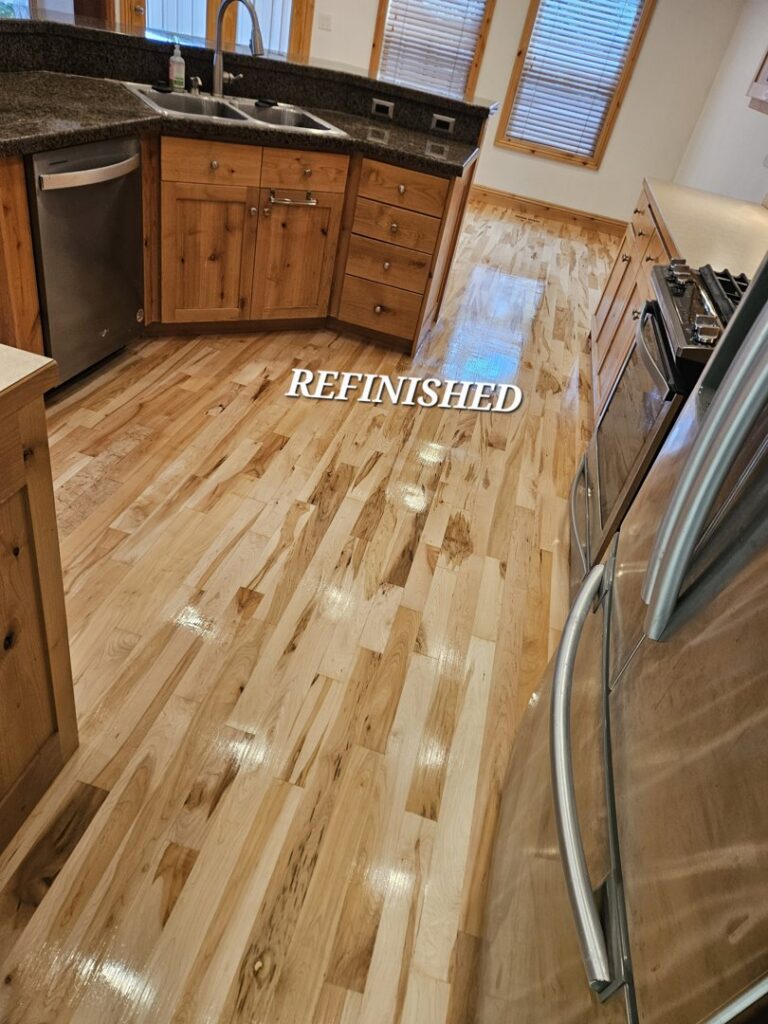 Beautifully refinished hardwood flooring in a kitchen by Quick Sand Flooring & Install LLC, a handyman service in Millcreek, UT.
