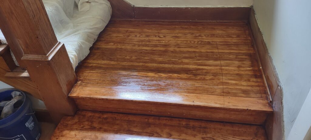 Beautifully refinished wooden stairs and landing completed by Handyashby in Saint Joseph, MO.