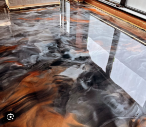 Close-up of a reflective orange and grey marbled epoxy floor installed by Lex Floors in Miami, FL.