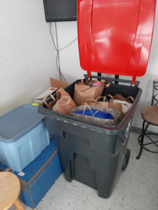 A Husker Refuse Services truck driving on a sunny day in Lincoln, NE, providing junk removal services.